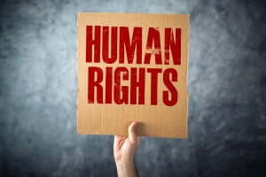 Man holding cardboard paper with HUMAN RIGHTS title, conceptual image